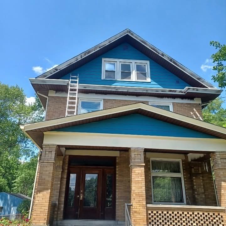 Brick house with siding and porch gable painted bright blue
