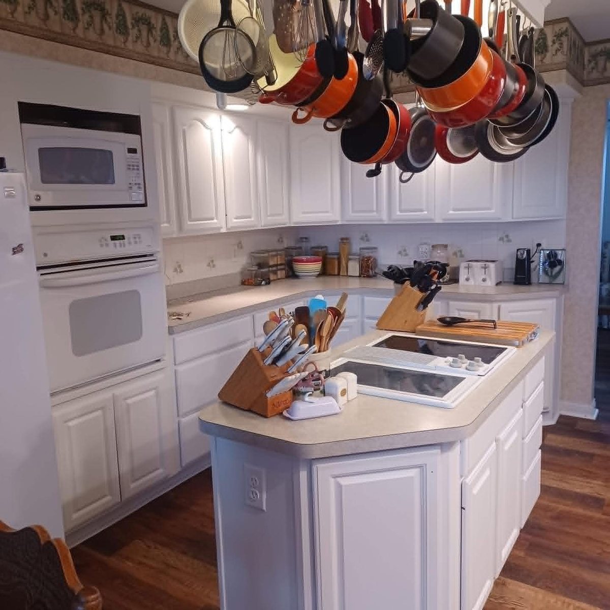The same kitchen with the cabinets and island painted white